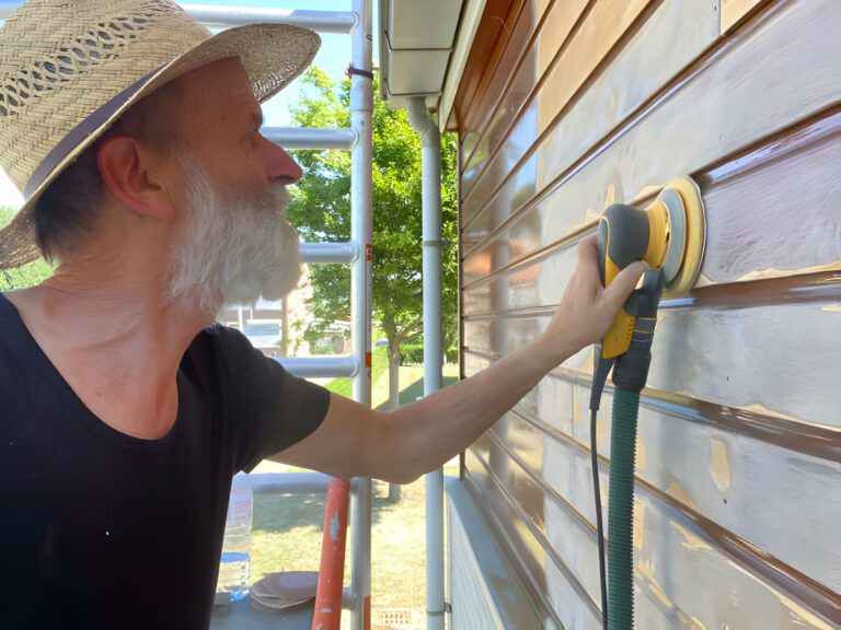 Man cleaning siding
