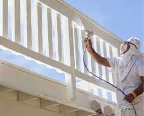 A deck being painted white