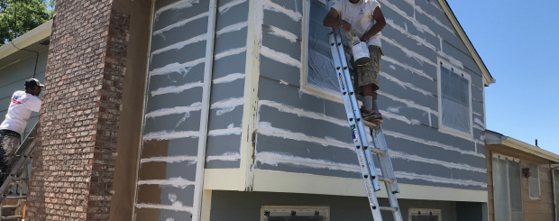 Men preparing to paint a home exterior