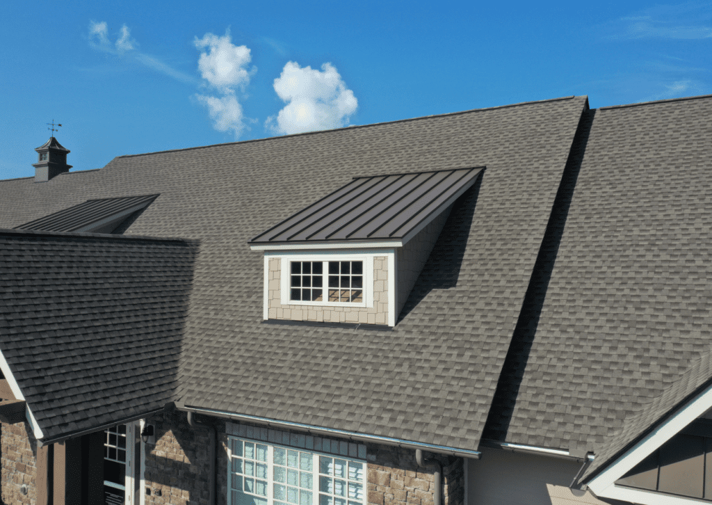 Aerial view of a beautifully installed roof by a premier roofing company, showcasing quality workmanship and design.