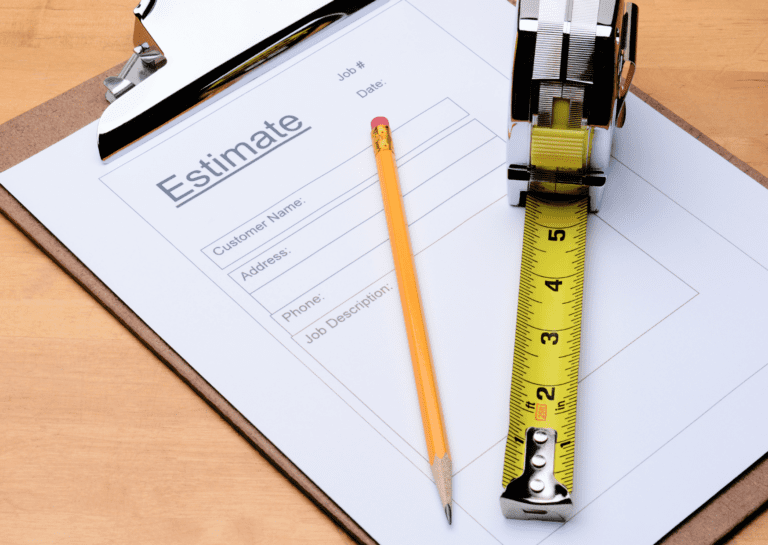 Clipboard with an estimate form, pencil, and tape measure. Contact us for a free estimate on roof repairs or installations.