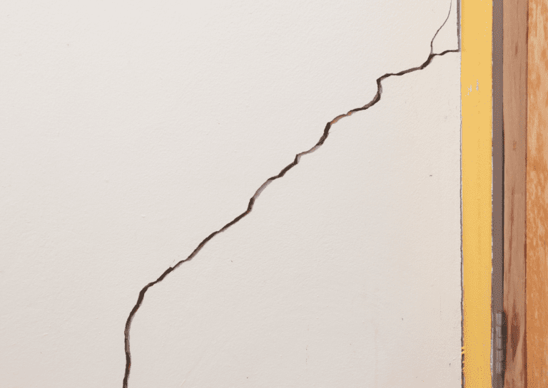 Learn how to repair wall cracks before painting to fix the visible crack near the door frame for a flawless finish.