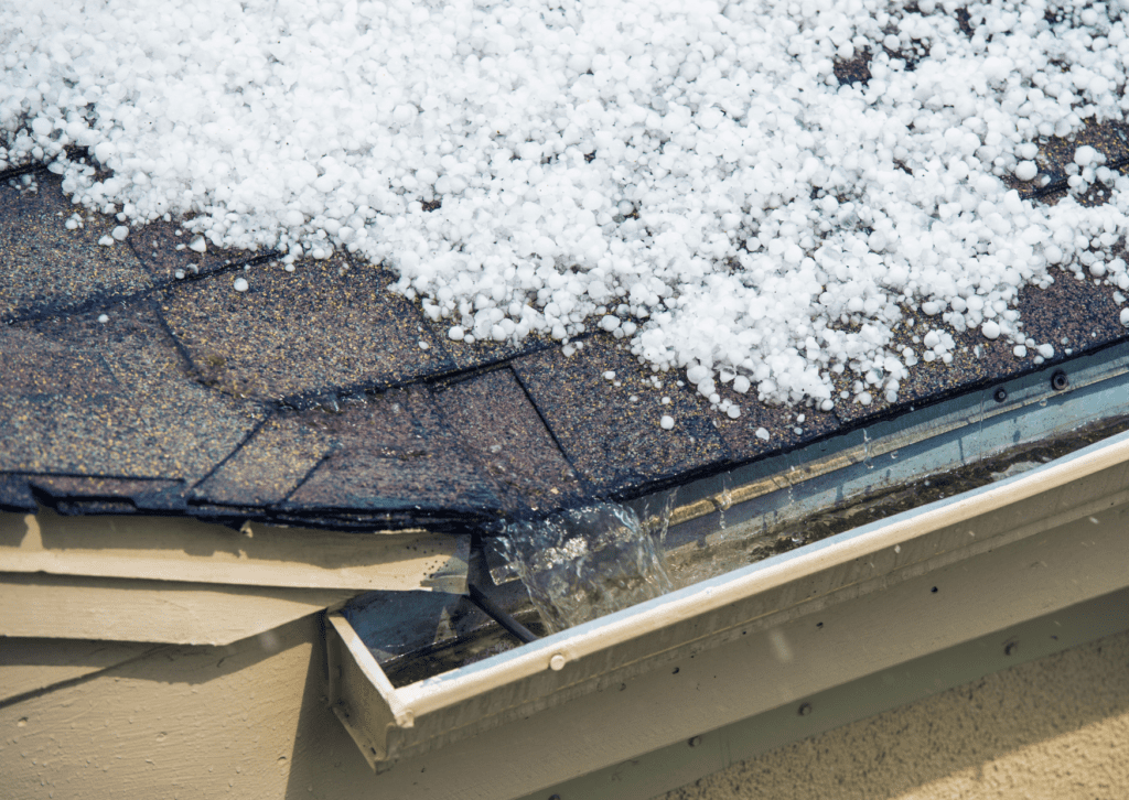 Close-up of hail damage on a roof, emphasizing the need for professional roof repair solutions.