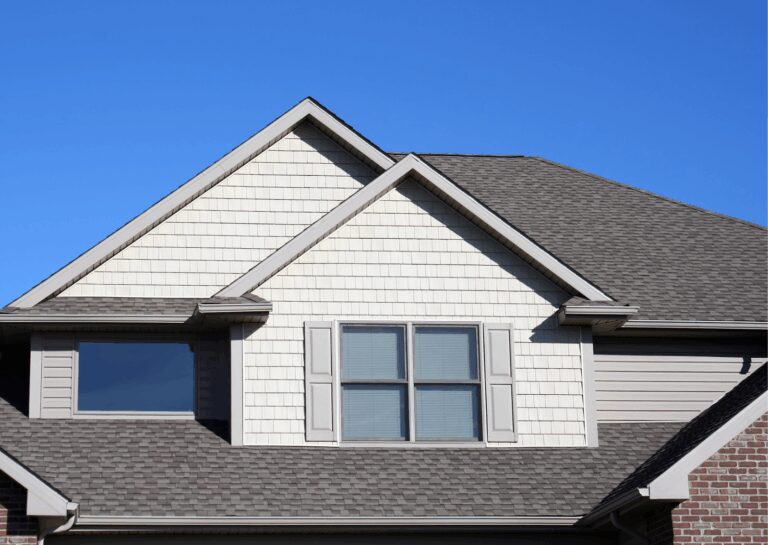 A two-story home with asphalt shingles and vinyl siding showcasing quality residential roofing services.